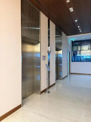 an empty lobby with elevators in a building at Modern 2BR with Balcony in Azizi Riviera 23 in Dubai