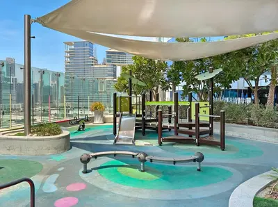 a park with a playground with a swing at Stylish 1-Bedroom Apartment at DAMAC Paramount in Dubai