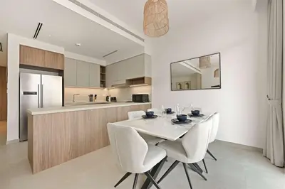 a dining room with a white table and chairs at Incredible Family Townhouse Villa I Sleeps 10 in Dubai