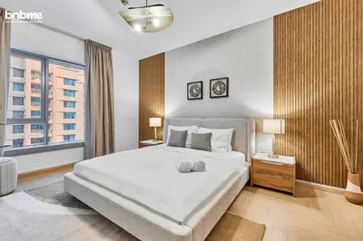 a bedroom with a large white bed and a window at bnbmehomes - 29 Boulevard Tower 1 in Dubai