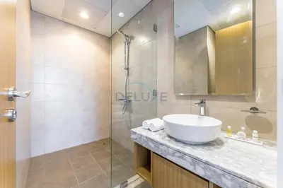 a bathroom with a sink and a shower at Minutes from Downtown Dubai and Burj Khalifa, Easy Metro Access, Seamless Connectivity to Marina and Palm Jumeirah - Aykon City 2 Tower C, Business Bay by Deluxe Holiday Homes in Dubai