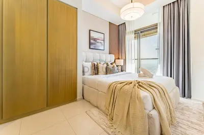 a bedroom with a large bed and a window at Minutes from Downtown Dubai and Burj Khalifa, Easy Metro Access, Seamless Connectivity to Marina and Palm Jumeirah - Aykon City 2 Tower C, Business Bay by Deluxe Holiday Homes in Dubai
