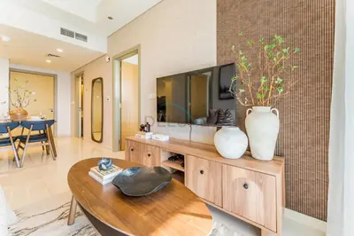 a living room with a table and a tv at Minutes from Downtown Dubai and Burj Khalifa, Easy Metro Access, Seamless Connectivity to Marina and Palm Jumeirah - Aykon City 2 Tower C, Business Bay by Deluxe Holiday Homes in Dubai