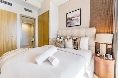 a white bedroom with a large white bed with pillows at Minutes from Downtown Dubai and Burj Khalifa, Easy Metro Access, Seamless Connectivity to Marina and Palm Jumeirah - Aykon City 2 Tower C, Business Bay by Deluxe Holiday Homes in Dubai