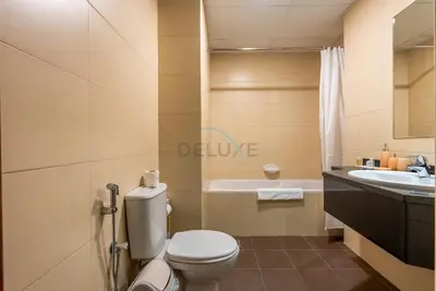 a bathroom with a toilet and a sink at Family-Friendly Apartment, Few Minutes Drive to Dubai Marina, Miracle Garden and Mall of the Emirates - Elite Residences 4, Sports City by Deluxe Holiday Homes in Dubai