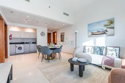 a living room with a couch and a table at Family-Friendly Apartment, Few Minutes Drive to Dubai Marina, Miracle Garden and Mall of the Emirates - Elite Residences 4, Sports City by Deluxe Holiday Homes in Dubai