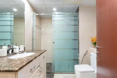 a bathroom with a shower and a toilet and a sink at White Sage JBR Sadaf Large 1BR on High Floor with two balconies in Dubai
