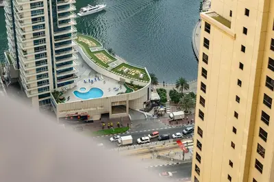 an aerial view of a building with a swimming pool at White Sage JBR Sadaf Large 1BR on High Floor with two balconies in Dubai