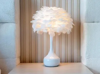 a white flower in a white vase on a table at Breathtaking 2Bedroom front-row Burj Khalifa & Fountain Views from Balcony, Grande Signature Residences in Dubai