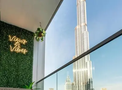 a window with a view of a tall skyscraper at Breathtaking 2Bedroom front-row Burj Khalifa & Fountain Views from Balcony, Grande Signature Residences in Dubai