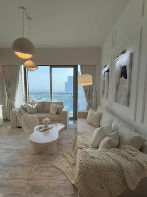 a living room with a white couch and a table at Breathtaking 2Bedroom front-row Burj Khalifa & Fountain Views from Balcony, Grande Signature Residences in Dubai
