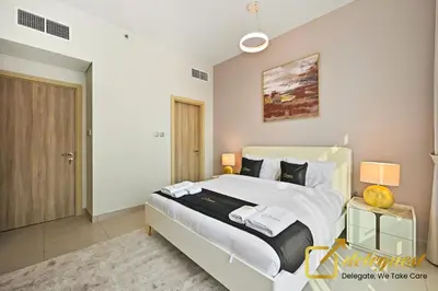 a bedroom with a large bed in a room at Luxury 2BR Dubai Hills Near Mall By Deleguest in Dubai