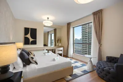 a bedroom with a large bed and a large window at Designer 2Bedroom in Rimal near to JBR Beach in Dubai