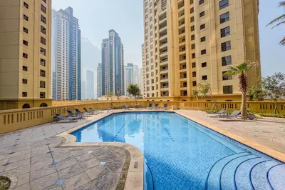 a large swimming pool in a city with tall buildings at Designer 2Bedroom in Rimal near to JBR Beach in Dubai