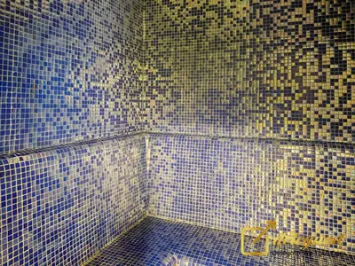 a bathroom with blue and yellow tiles on the wall at Modern Comfort Studio DAMAC Hills 1 in Dubai