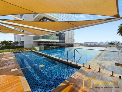 a swimming pool on the roof of a building at Modern Comfort Studio DAMAC Hills 1 in Dubai