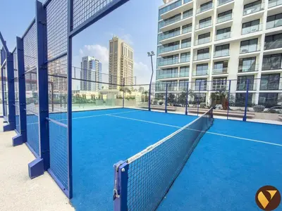 a tennis court in front of a building at Vogue JVC Binghatti Phoenix near Circle Mall, Studio Apartment with Balcony and Access to all Amenities in Dubai