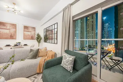 a living room with a couch and a large window at ShoresInn - Sleek & Modern Stay at Dubai Marina in Dubai