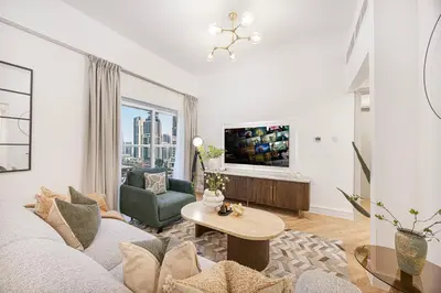 a living room with a couch and a table at ShoresInn - Sleek & Modern Stay at Dubai Marina in Dubai