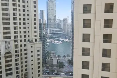 a view of a river between two tall buildings at Luxury 2BR l High Floor l Marina View l JBR in Dubai