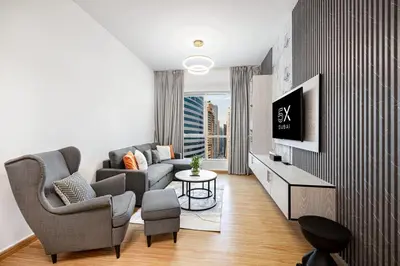 a living room with a couch and a tv at FiveX Luxury 2BR at Lake Point JLT in Dubai