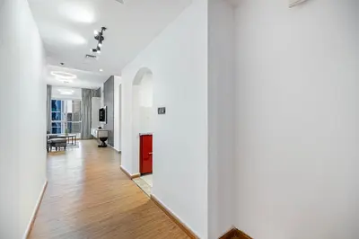 a hallway with white walls and wooden floors at FiveX Luxury 2BR at Lake Point JLT in Dubai