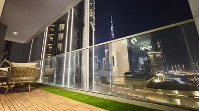a balcony with a view of a city at night at Skyline Vida Dubai Mall 3 Bedroom Apartment I Burj Khalifa Views I Direct Access Dubai Mall I Parking, Gym, Wi-Fi & Pool in Dubai