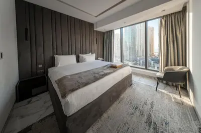 a bedroom with a large bed and a large window at Luxury 2BR Huge New Apartment in Dubai