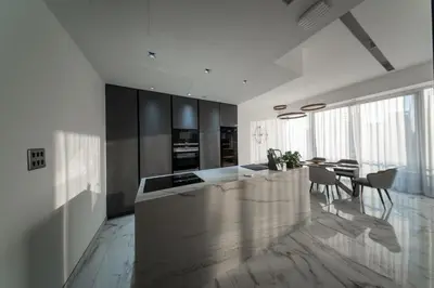 a kitchen with a counter and a table and chairs at Luxury 2BR Huge New Apartment in Dubai