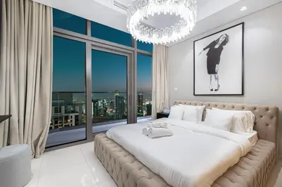 a bedroom with a large bed and a large window at Luxe 3BR with Infinity Pool and Burj Khalifa View l High Floor in Dubai
