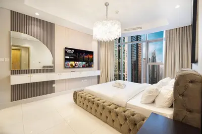 a bedroom with a large bed and a large window at Luxe 3BR with Infinity Pool and Burj Khalifa View l High Floor in Dubai