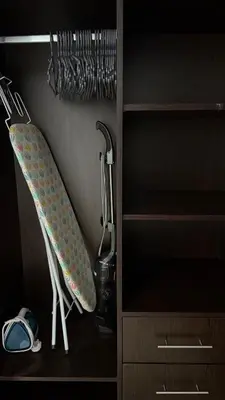 a closet with a ironing board and a sink at Huge Studio DMCC Metro Close to Marina in Dubai