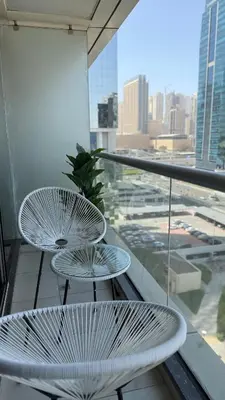 two tables on a balcony with a view of a city at Huge Studio DMCC Metro Close to Marina in Dubai