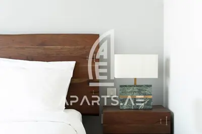 a bedroom with a bed and a table with a lamp at 2BR Address JBR - Direct Beach Access & Top Views in Dubai