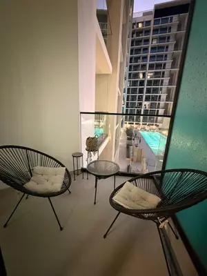 a room with two chairs and a glass table at Luxury 1BR Binghatti JVC in Dubai