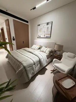 a bedroom with a large bed and a chair at Luxury 1BR Binghatti JVC in Dubai