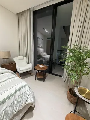 a bedroom with a bed and a living room at Luxury 1BR Binghatti JVC in Dubai