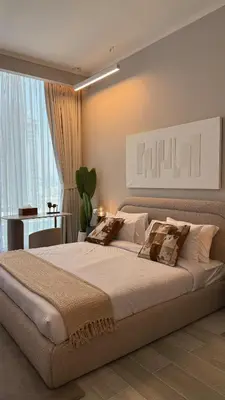 a bedroom with a large bed and a large window at Stunning Brand New Stylish Studio in JVC in Dubai