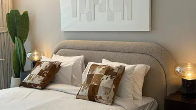 a bedroom with a bed with two pillows on it at Stunning Brand New Stylish Studio in JVC in Dubai