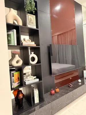 a living room with a tv on a shelf at HYDE WALK STUDiO BURj ViEW & PREMiUM COMFORt in Dubai
