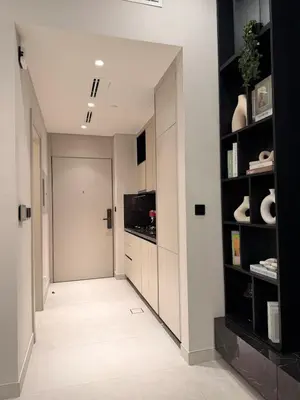 a hallway with a door and shelves in a house at HYDE WALK STUDiO BURj ViEW & PREMiUM COMFORt in Dubai
