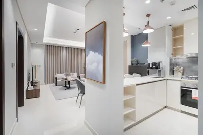 a kitchen and living room with white countertops at Premium 1BHK Apartment Nobles Tower by Czechin in Dubai