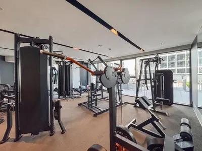 a gym with lots of equipment in a building at Premium 1BHK Apartment Nobles Tower by Czechin in Dubai
