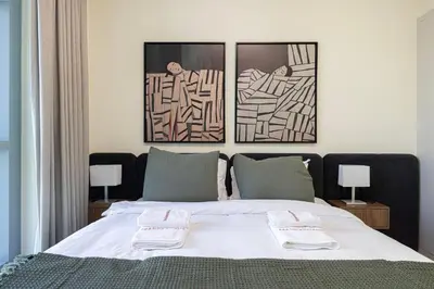 a bedroom with a bed with two towels on it at Chic 1BR near Burj Khalifa - Downtown in Dubai