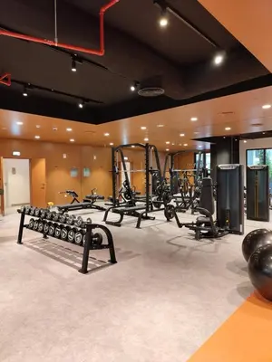 a gym with a row of treadmills and machines at Seaside 1-Bedroom Apartment with Beach Access at Port De La Mer in Dubai