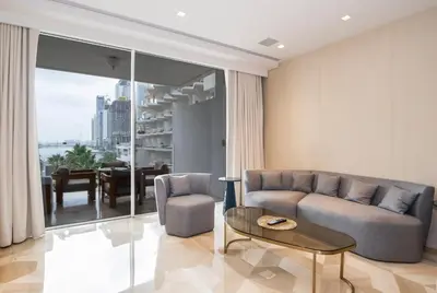a living room with a couch and a table at New Arabian Five Palm Residences in Dubai