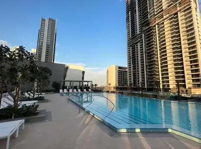 a large swimming pool in a city with tall buildings at Creek Harbour Home Burj Khalifa Downtown View in Dubai