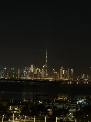 a night view of a city with a skyline at Creek Harbour Home Burj Khalifa Downtown View in Dubai