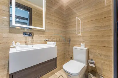 a bathroom with a white sink and a toilet at Perfectly Positioned Near Dubai Miracle Garden and Butterfly Garden, Quick Drive to Global Village, Adhara Star, Arjan by Deluxe Holiday Homes in Dubai