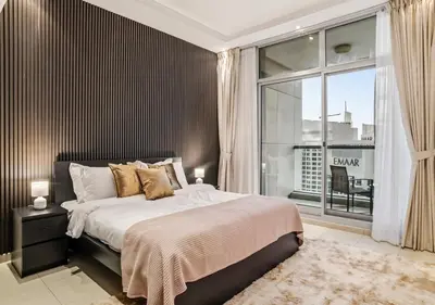 a bedroom with a bed and a large window at Two Bedroom Apartment at JBR with Marina and Bluewaters Views in Dubai